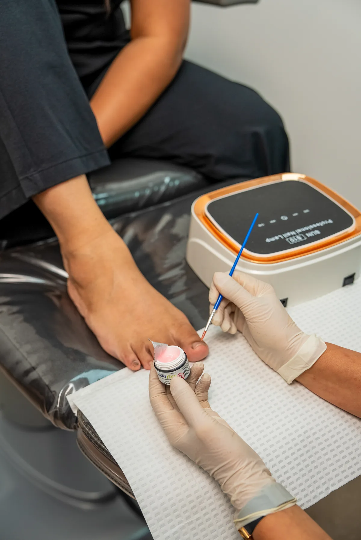 A podiatrist reducing hard skin on the sole of a patient's foot