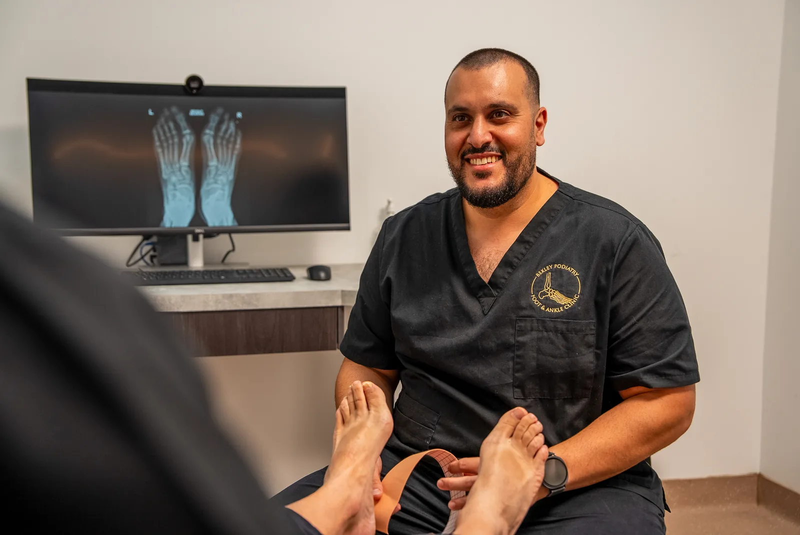 A podiatrist performing a minor nail procedure in the Bexley clinic
