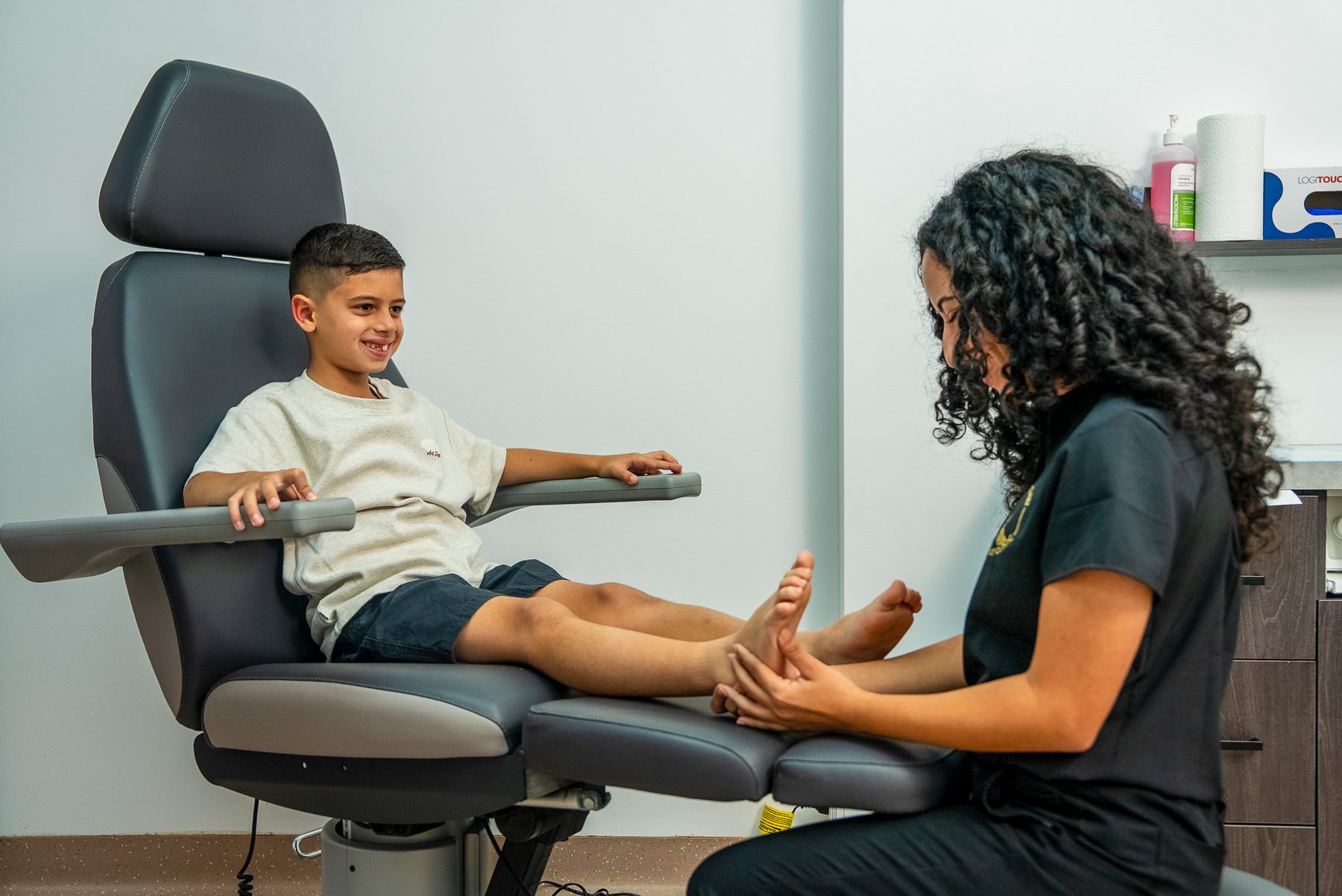 A Bexley Podiatry podiatrist treating a young patient's foot