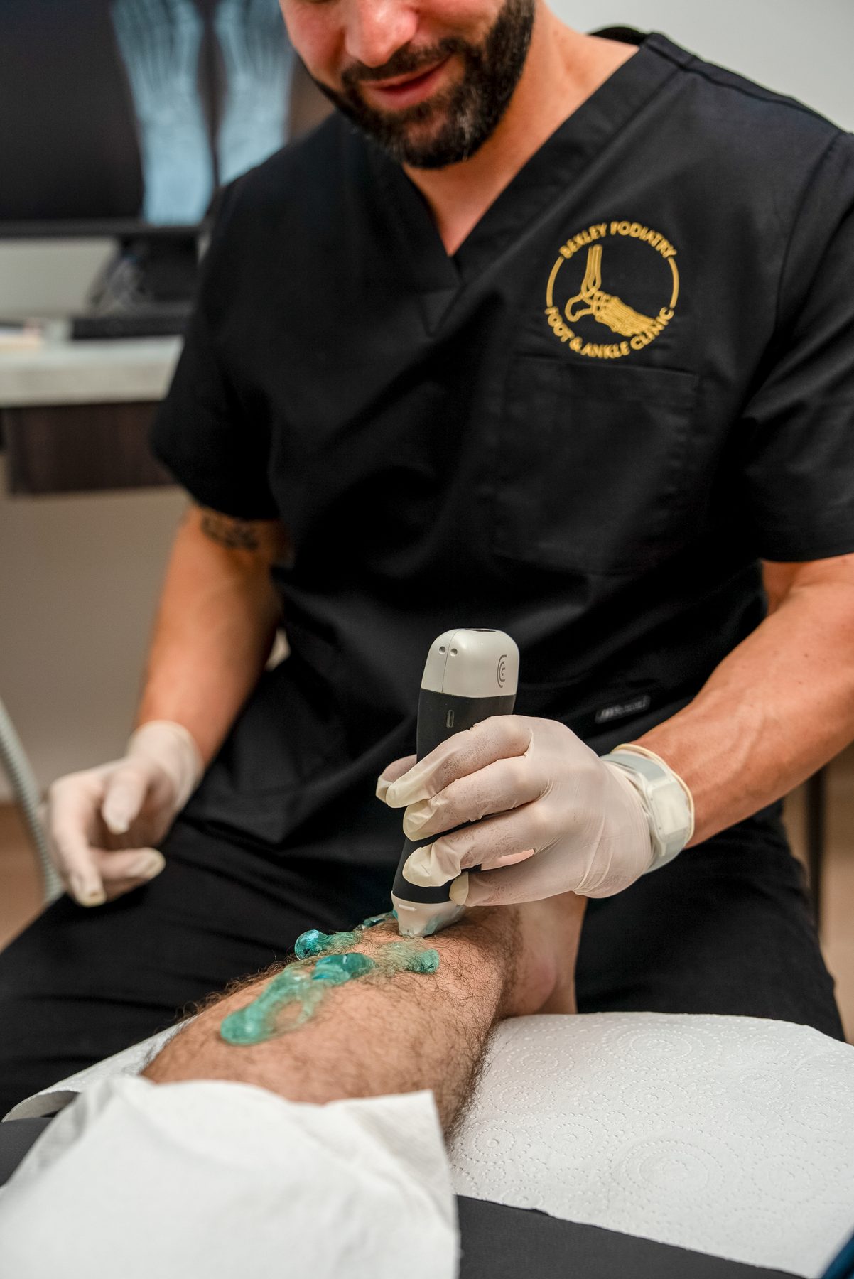A Bexley Podiatry podiatrist delivering shockwave therapy to a patient's foot